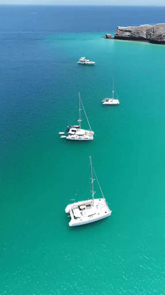 Boats in turquoise water - Lowtide Sailing