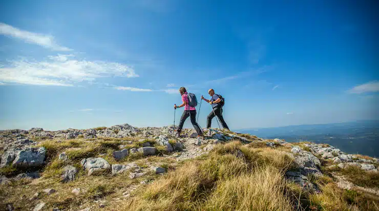Hikers on a mountain top - Lowtide Sailing