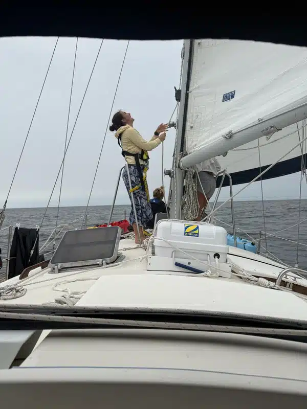 Student hoisting sails and learning sail trim